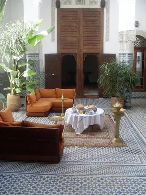a living room with couches and a table in it at Riad Tayba in Fès