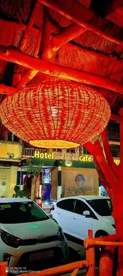 a red ceiling with cars parked in front of a hotel at Hotel Safari Week end in Midelt