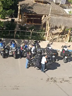 a group of motorcycles parked in front of a hut at Hotel Safari Week end in Midelt