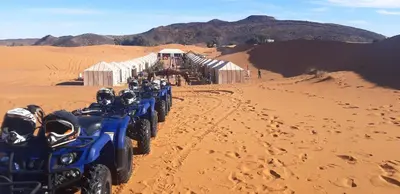a group of atvs parked in the desert at Camp Under Stars in Merzouga