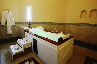 a bathroom with a sink and a bath tub at Berbère Palace in Ouarzazate