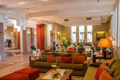 a large living room with couches and tables at Berbère Palace in Ouarzazate