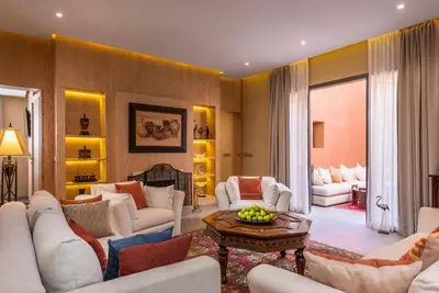 a living room with white couches and a table at Berbère Palace in Ouarzazate