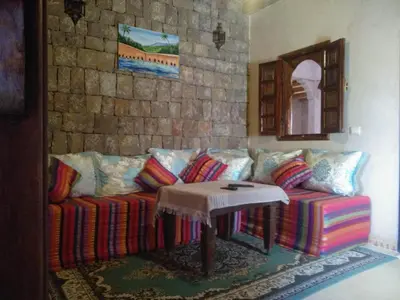 a living room with a couch and a table at Chambre d'hôtes aya in Ouzoud