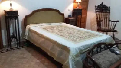 a bedroom with a bed and two chairs at Citadelle d'Orient in Aghmat