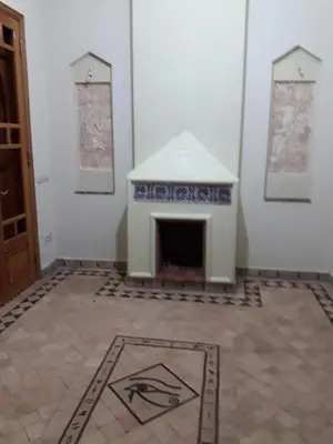 a room with a fireplace and a tile floor at Citadelle d'Orient in Aghmat
