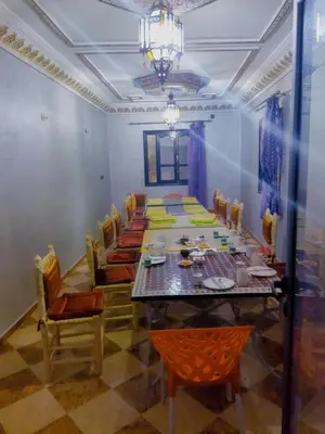 a long dining room with a long table and chairs at Dar Marwa in Ouzoud