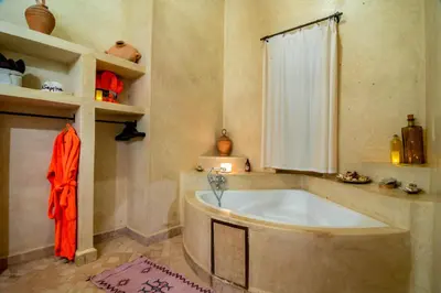 a large bath tub in a room with a window at Villa Septha in Marrakech