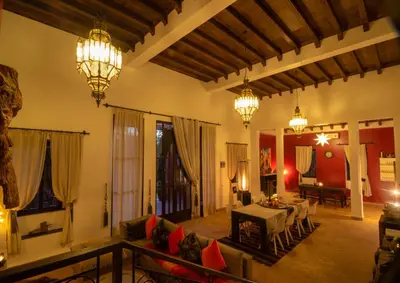 a living room with two chandeliers and a table at Villa Septha in Marrakech