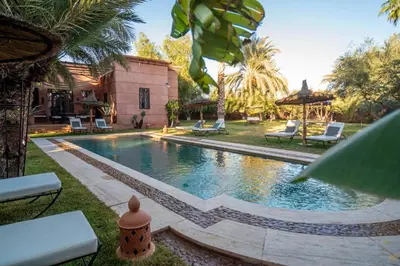 a swimming pool in the yard of a house at Villa Septha in Marrakech