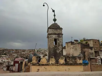 an old building with a statue on top of it at Dar Ouassim in Fès