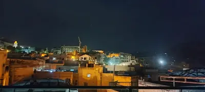 a view of a city at night at Dar Ouassim in Fès