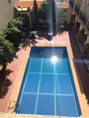 an overhead view of a swimming pool in a yard at Hôtel Zaghro in Ouarzazate