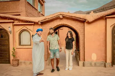 a group of three people standing in front of a building at Ouednoujoum Ecolodge & Spa in Ouarzazate