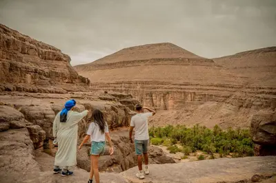 a group of three people looking at a canyon at Ouednoujoum Ecolodge & Spa in Ouarzazate