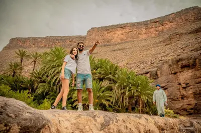 a man and a woman standing on a rock at Ouednoujoum Ecolodge & Spa in Ouarzazate