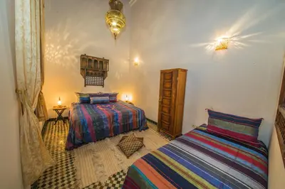 a bedroom with two beds in a room at Riad Gzira Fez in Fès
