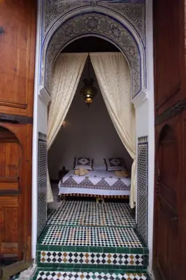 a bedroom with a bed with a canopy at Riad Gzira Fez in Fès