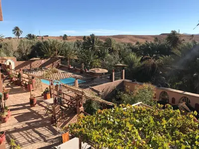 an aerial view of a resort with palm trees at Riad Dar Bab Todra in Tinerhir
