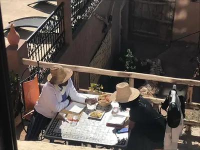 a group of three people sitting at a table at Riad Dar Bab Todra in Tinerhir