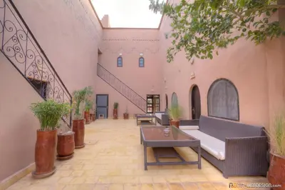 a courtyard with a couch and a table in a building at Guest House Bagdad Café in Aït Ben Haddou