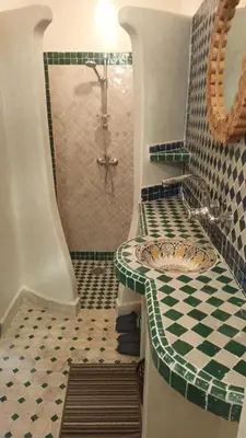a bathroom with a shower with a sink and a shower at Dar Essalama Dades in Akhendachou nʼAït Ouffi