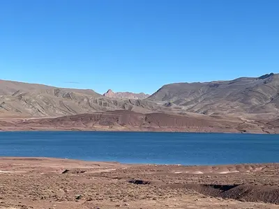 a large body of water with mountains in the background at Dar Essalama Dades in Akhendachou nʼAït Ouffi