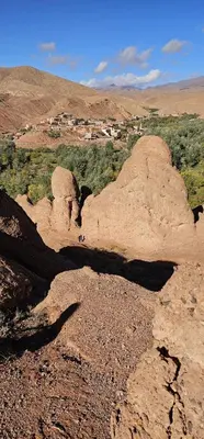 a person standing on top of a rock formation at Dar Essalama Dades in Akhendachou nʼAït Ouffi