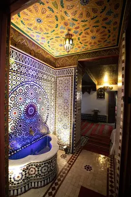 a room with a fountain with a patterned ceiling at Dar Mayssae in Fès