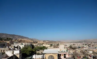 a view of a city with mountains in the background at Dar Mayssae in Fès