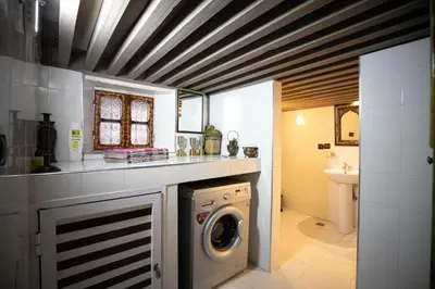 a laundry room with a washer and dryer in it at Dar Mayssae in Fès