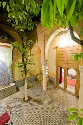 a room with a tree on a tiled floor at Riad La Maison D'à Côté in Meknès