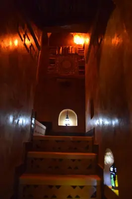 a church with stairs and a window and a light at Kasbah Assafar in Kalaat MGouna