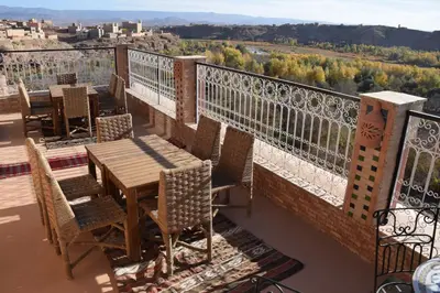 a table and chairs on a balcony with a view at Kasbah Assafar in Kalaat MGouna