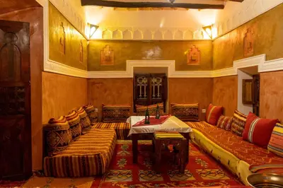 a living room with a couch and a table at Kasbah Assafar in Kalaat MGouna