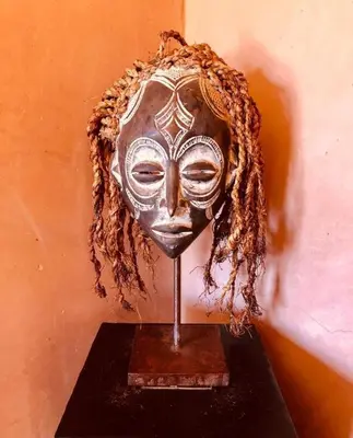 a mask is on a stand in a wall at Kasbah Isfoula and spa in Aït Ben Haddou