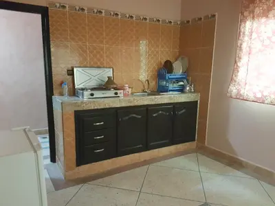 a kitchen with a sink and a counter top at Résidence MARWA in Ouarzazate
