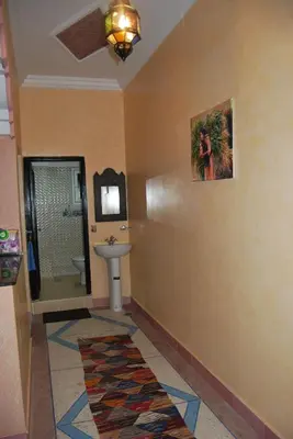 a bathroom with a sink and a mirror at Résidence MARWA in Ouarzazate
