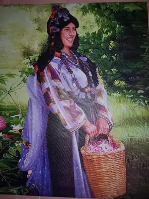 a painting of a woman holding a basket at Résidence MARWA in Ouarzazate