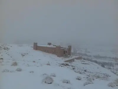 a building on top of a snow covered hill at Kasbah Izoran in Midelt