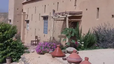 a house with some bells in the yard at Kasbah Izoran in Midelt
