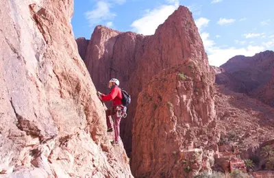 a man standing on the side of a mountain at A Secret Garden in Tinerhir