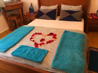 a bed with two towels and two hearts on it at A Secret Garden in Tinerhir