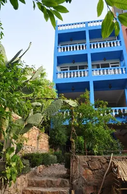 a blue building with stairs in front of it at A Secret Garden in Tinerhir