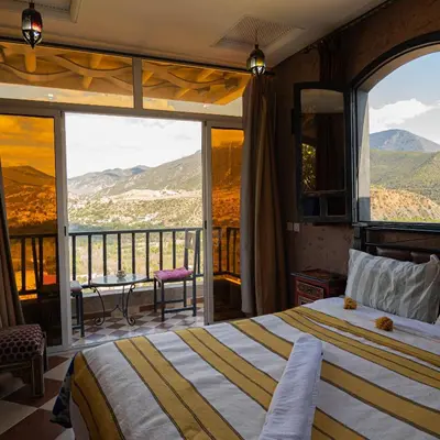a bedroom with a bed and a balcony at Dar Soulaimane in Marrakech