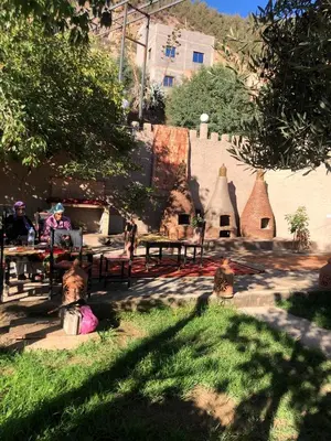 a group of people sitting at a picnic table in a park at Dar Soulaimane in Marrakech
