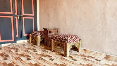 a pair of chairs sitting next to a wall at Dar Soulaimane in Marrakech