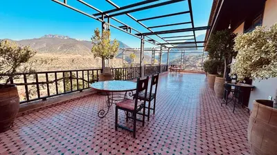 a table and chairs on a balcony with a view at Dar Soulaimane in Marrakech