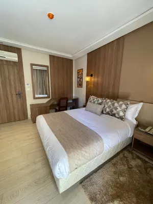 a bedroom with a large white bed in a room at Hotel De Nice in Meknès