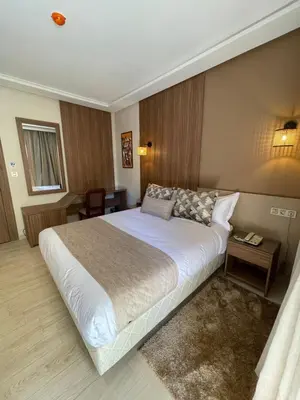 a bedroom with a large white bed in a room at Hotel De Nice in Meknès
